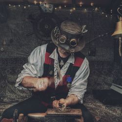 Worker wearing hat working in workshop