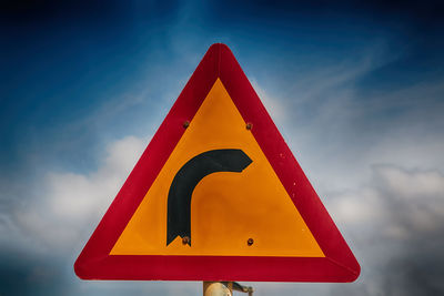 Low angle view of road sign against sky