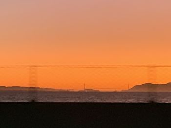 Scenic view of sea against orange sky