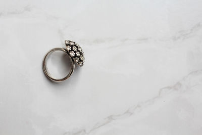 High angle view of wedding rings on snow