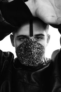 Close-up portrait of young man wearing mask