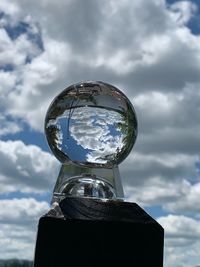 Low angle view of crystal ball against sky