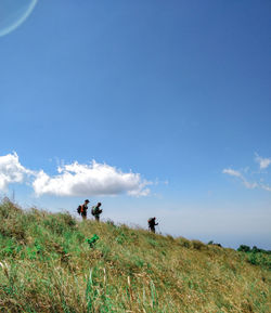 People on field against sky