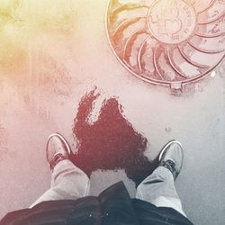 Low section of person standing on tiled floor