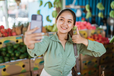 Portrait of young woman using mobile phone