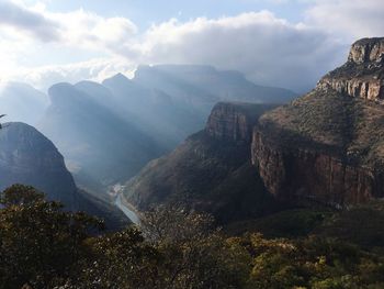 Scenic view of mountains against cloudy sky