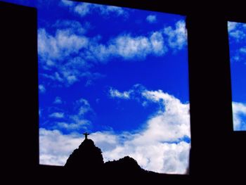 Low angle view of silhouette blue sky