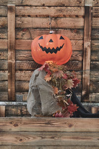 View of pumpkin hanging on wood against wall