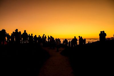 Silhouette people against sky during sunset