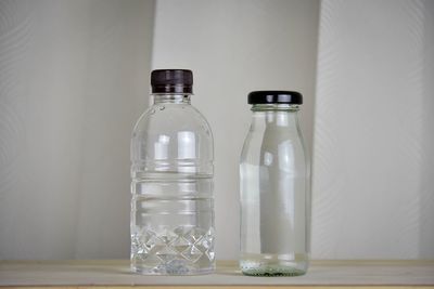 Close-up of empty glass bottle on table