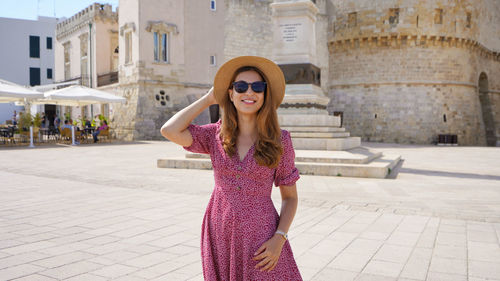 Panoramic view of fashionable cheerful woman in otranto, salento, italy