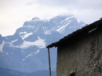 Scenic view of snow covered mountains against sky