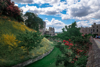 Panoramic shot of canal amidst buildings against sky