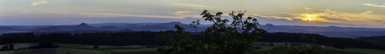 Scenic view of mountains against sky at sunset