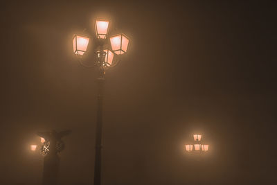 Low angle view of illuminated street light at night