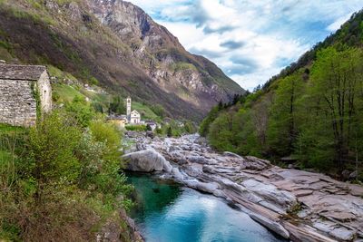 Scenic view of river amidst mountains against sky