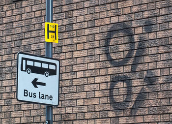 Bus lane sign by wall