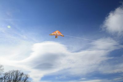 Low angle view of kite flying against sky