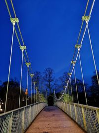 Footbridge against clear blue sky