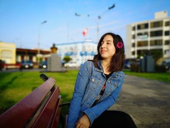 Young woman sitting on a car