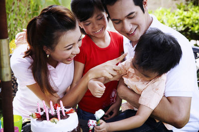 Family celebrating birthday in lawn