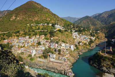 High angle view of townscape by sea against sky