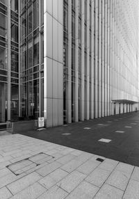 Walkway by modern building in city