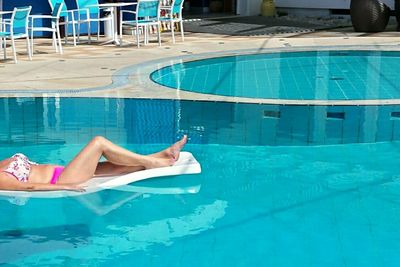 Woman lying in swimming pool