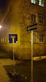 Road sign on street at night