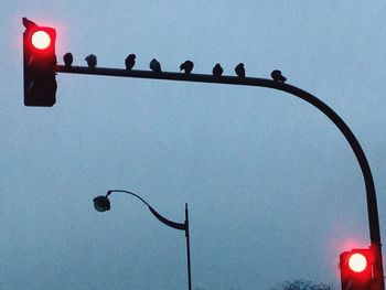 Low angle view of street light against sky