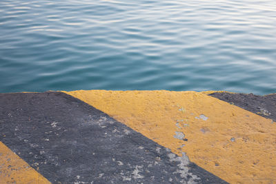 High angle view of yellow wall by sea