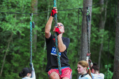 Man holding rope hanging on clothesline