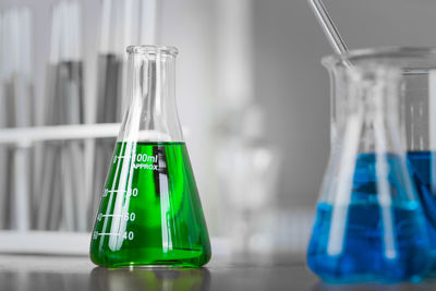 Close-up of colorful chemicals in flask at laboratory