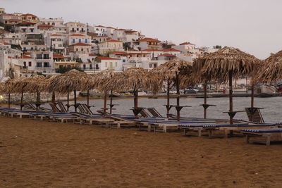 Scenic view of beach by buildings against sky