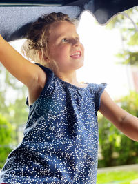 Close-up of a smiling girl looking away