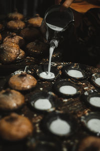 Cropped hands of woman preparing food in kitchen