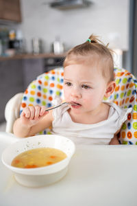 High angle view of cute boy eating food at home