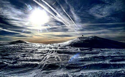 Scenic view of snow covered mountains against sky