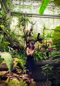 Woman standing in greenhouse