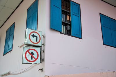 Road sign on wall of building