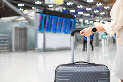 Man holding umbrella at airport