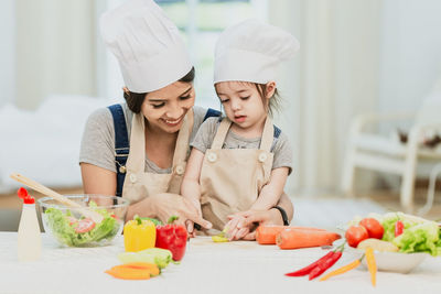 Midsection of woman having food in kitchen