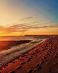 Scenic view of beach against sky during sunset