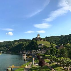 Cityscape with a castle on the top of hill and the river on right side