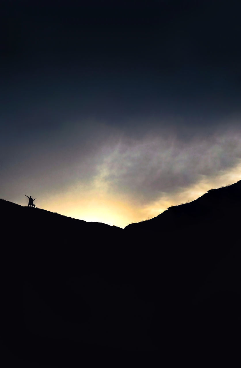 LOW ANGLE VIEW OF SILHOUETTE MOUNTAINS AGAINST SKY