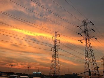 Silhouette electricity pylon against sky during sunset