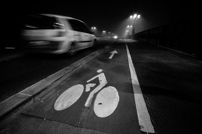 Blurred motion of bicycle on road at night