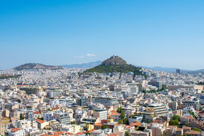 Townscape against clear blue sky