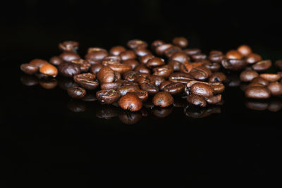 Close-up of roasted coffee beans against black background
