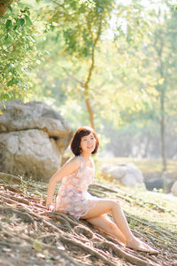 Young woman sitting on a tree